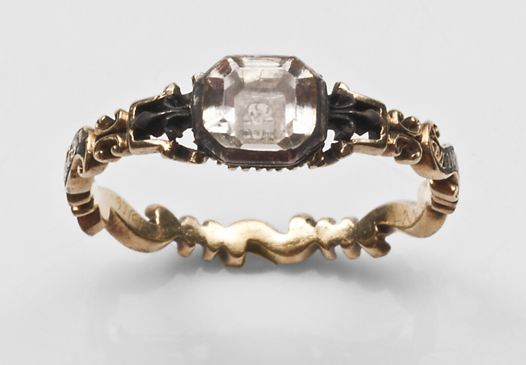 Rococo designed mourning ring with skull under crystal and fleur-de-lis shouders, collection of Hayden Peters