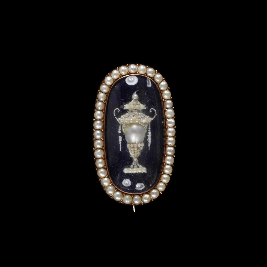 Gold and enamel set with seed pearls, half pearls and hair. Image courtesy of the V&A Museum.