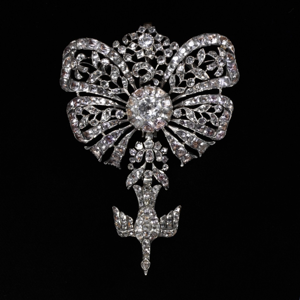 Pendant, pastes (glass) set in silver in the form of an openwork bow with flowers, and with a pendant dove.