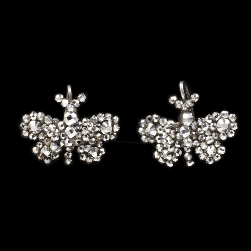 These butterfly earrings are typical of the cut steel goods exported from France to much of Europe and America in the second half of the nineteenth century. The flourishing trade was bolstered by the need for jewellery to wear during periods of secondary mourning (an interim period between full and semi-mourning in the Victorian era) as well as by fashionable status. In London in 1882 it was reported that steel butterflies had begun to perch on bonnets.