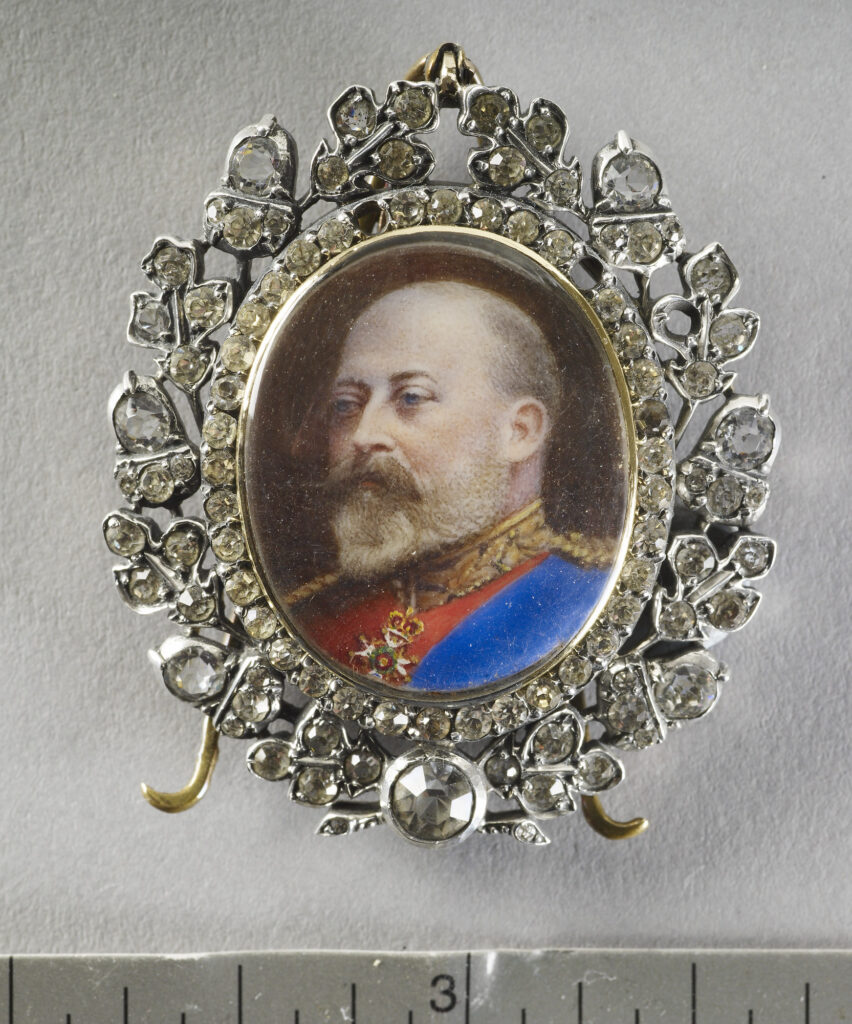 Miniature of Edward VII, head and shoulders, in field marshal's uniform with the ribbon of the Order of the Garter and the Sovereign's neck badge of the Order of the Bath, set in a diamond-mounted bezel fitted with an easel stand but originally a brooch clasp, the reverse with an ERVII cipher in enamel and bearing the date 1902. Image courtesy of Royal Collection Trust UK.