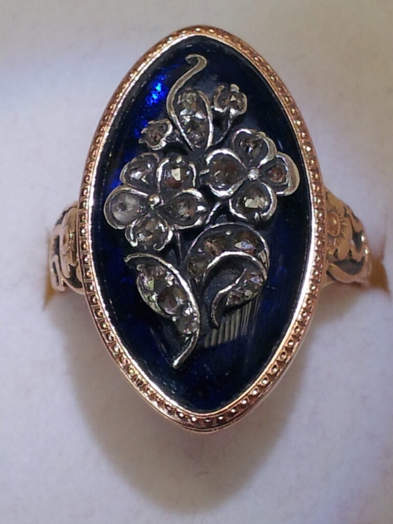 Forget-me-not and rose ring, with blue enamel, and diamond. Image courtesy of Julie Strawinski.