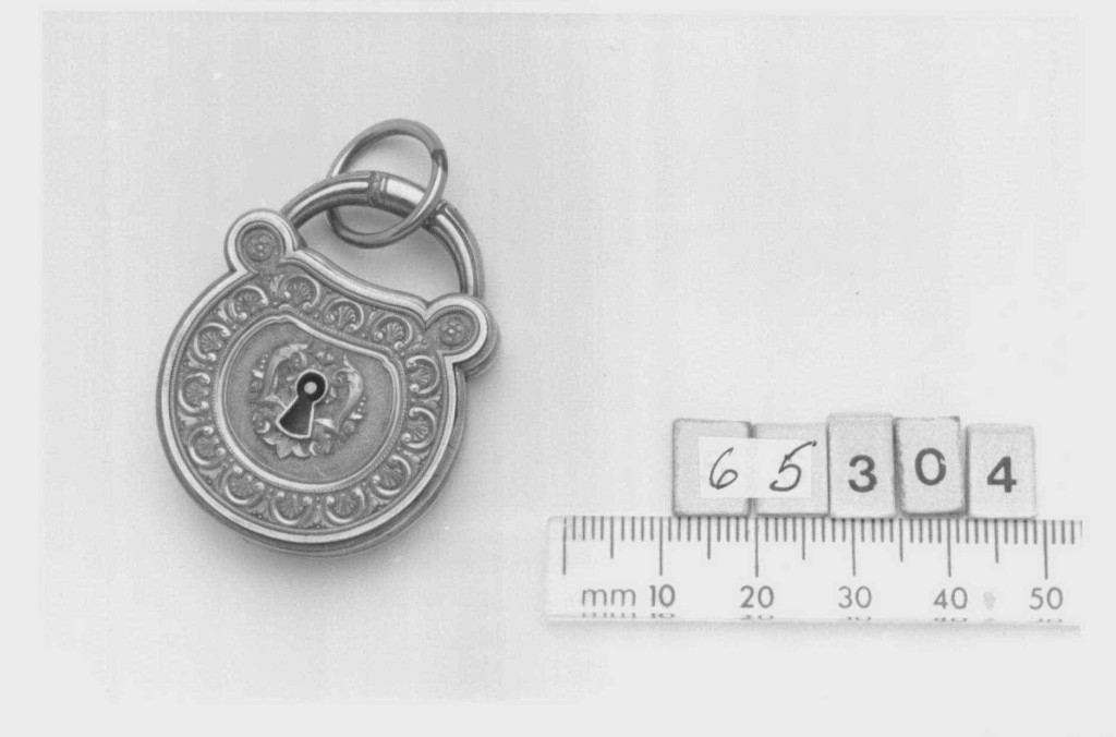 Provenance: Locket given by Mary, Duchess of York to Queen Victoria, 1900. Description: Chased gold locket in the shape of a padlock. Image courtesy of Royal Collection Trust UK.