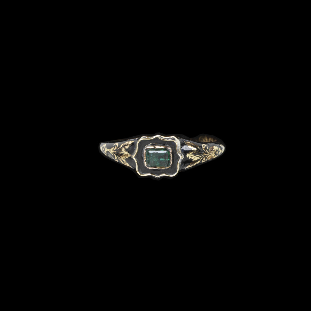 Gold memorial ring decorated with black enamel and an emerald. Engraved with a crown and the initials 'WR' made to commemorate William IV's death. London Hallmarks for 1837