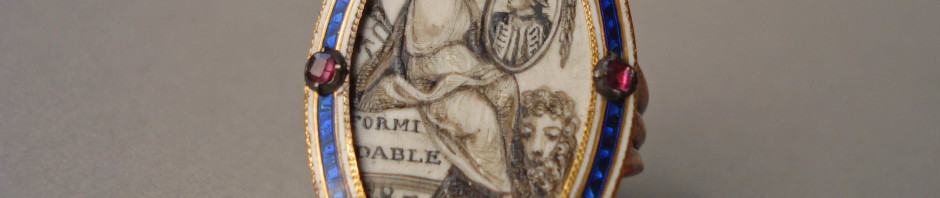 Mourning ring; gold; marquise bezel studded round border with garnets in settings over bands of blue and white enamel; contains figure of Britannia(?) sitting on stern of vessel on which is a name, and wreathing the picture of an admiral; lion at her feet with paw on dead dove. No maker's mark.