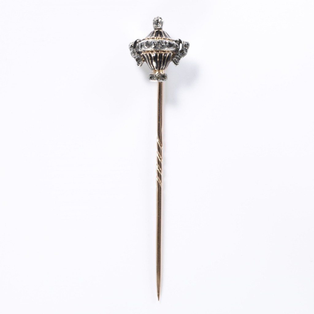 Pin with urn-shaped enamelled gold head, silver, set with brilliant-cut diamonds.