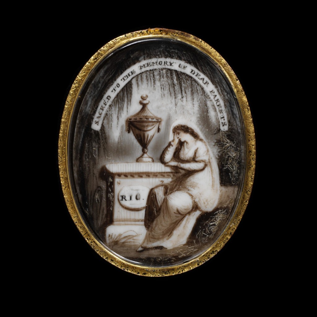 Gilt copper frame enclosing a miniature of a woman by a Tomb beneath the inscription Sacred to the Memory of Dear Parents, England, about 1800. Image courtesy of the V&A Museum.