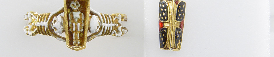 Mourning-ring; enamelled gold, the hoop enamelled white, in the form of two skeletons supporting a coffin-shaped bezel with moveable lid fastened with a pin and ornamented with a Maltese cross once enamelled red, on a black ground with hearts reserved in the metal, an enamelled cinquefoil at one end. Inside the coffin is a tiny white-enamelled skeleton. At the back of the bezel ares two clasped hands.