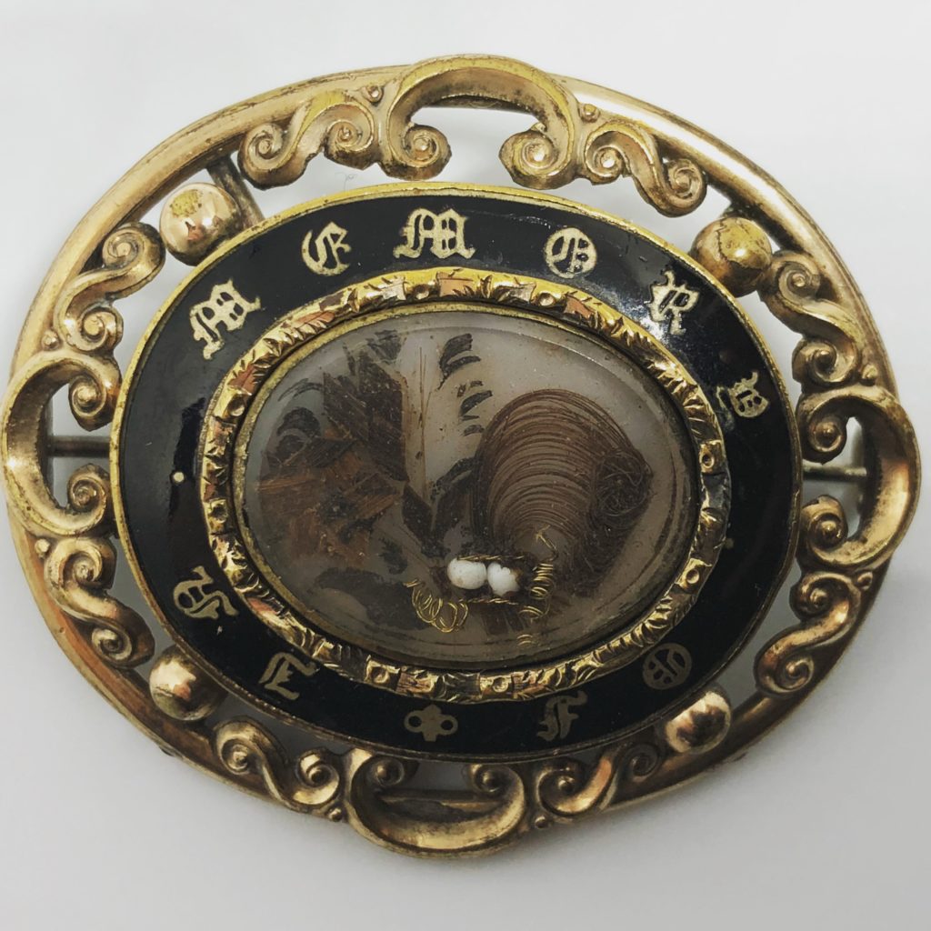 1840s palette-worked hair brooch with black enamel, pearl and gold wire.