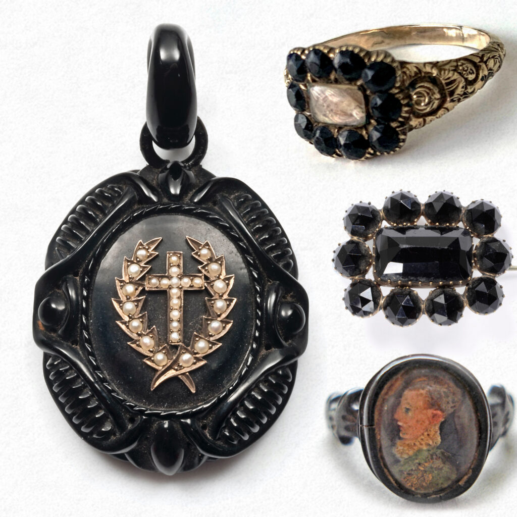 A variety of jet jewellery. A pendant, 19th century ring, brooch and ring from the Middle Ages.