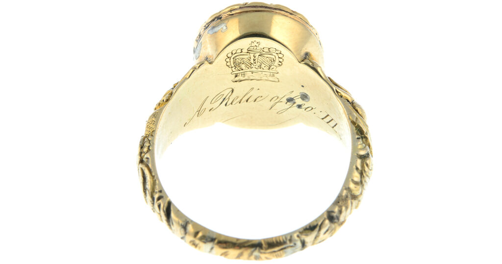 Side of c.1820 George III mourning ring showing reverse with coronet and inscription 'A Relic of Geo III'.