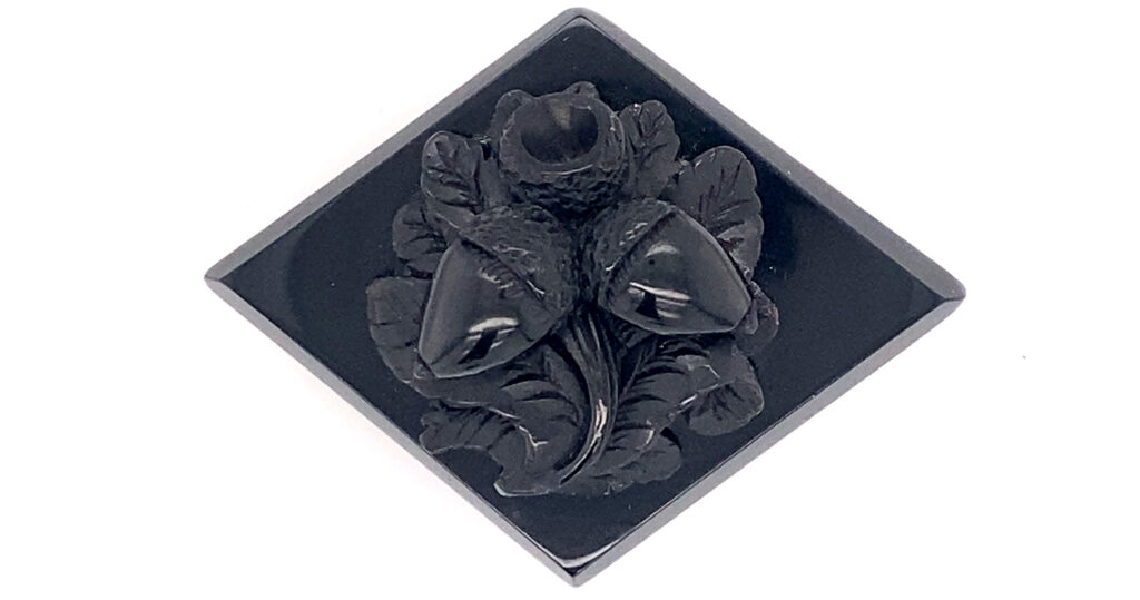 Acorn and fern design in a Whitby Jet. Courtesy of the Whitby Jet Museum